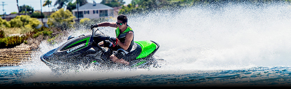 Man on a Kawasaki Jet Ski® STX®-15F racing on the water